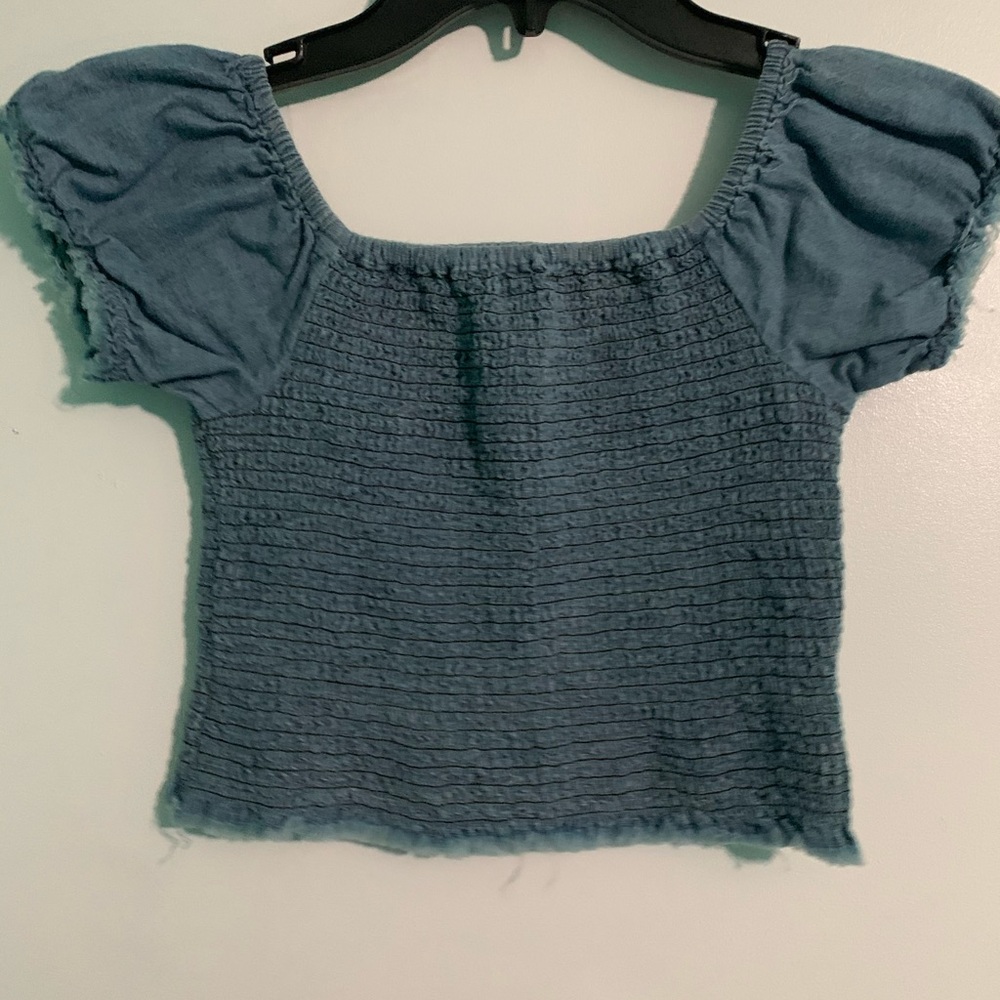 Blue off the shoulder shirt and a black shirt